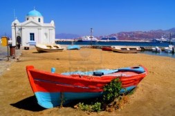 14362842-old-boat-and-traditional-blue-dome-church-on-the-shore-of-mykonos-island-greece